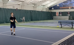 SU student plays practices for the club tennis team at the Barnes Center